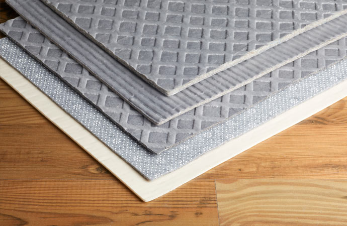 Exploring various types of waterproof rug pads for a spill-proof home.