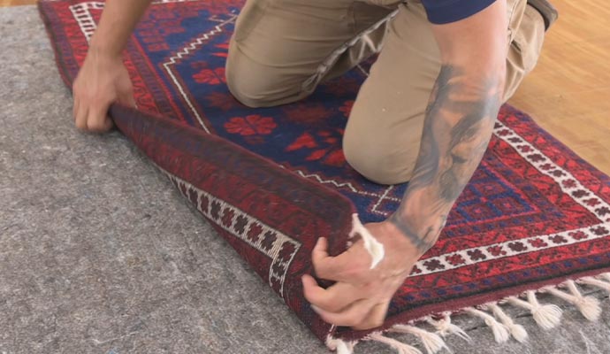 Professional worker replacing rug underlay