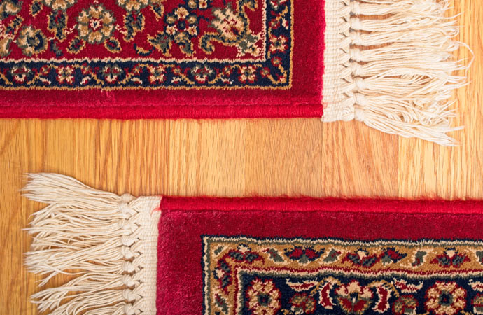 Showcasing an elegant Oriental rug with fringe on a beautiful oak hardwood floor.