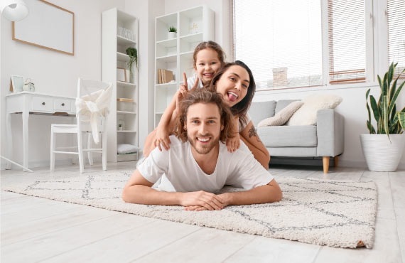 a family sitting on a pile rug