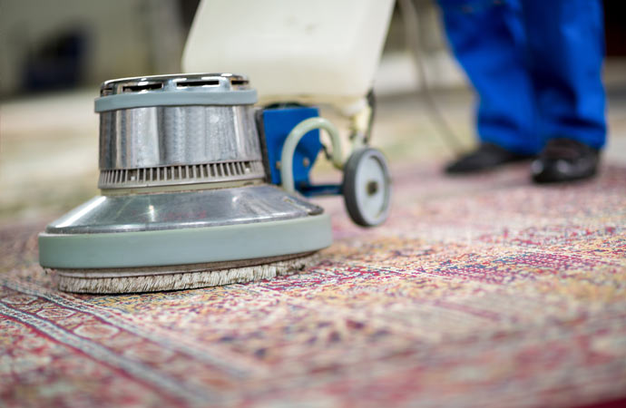 Using an electric vacuum cleaner for efficient rug cleaning.